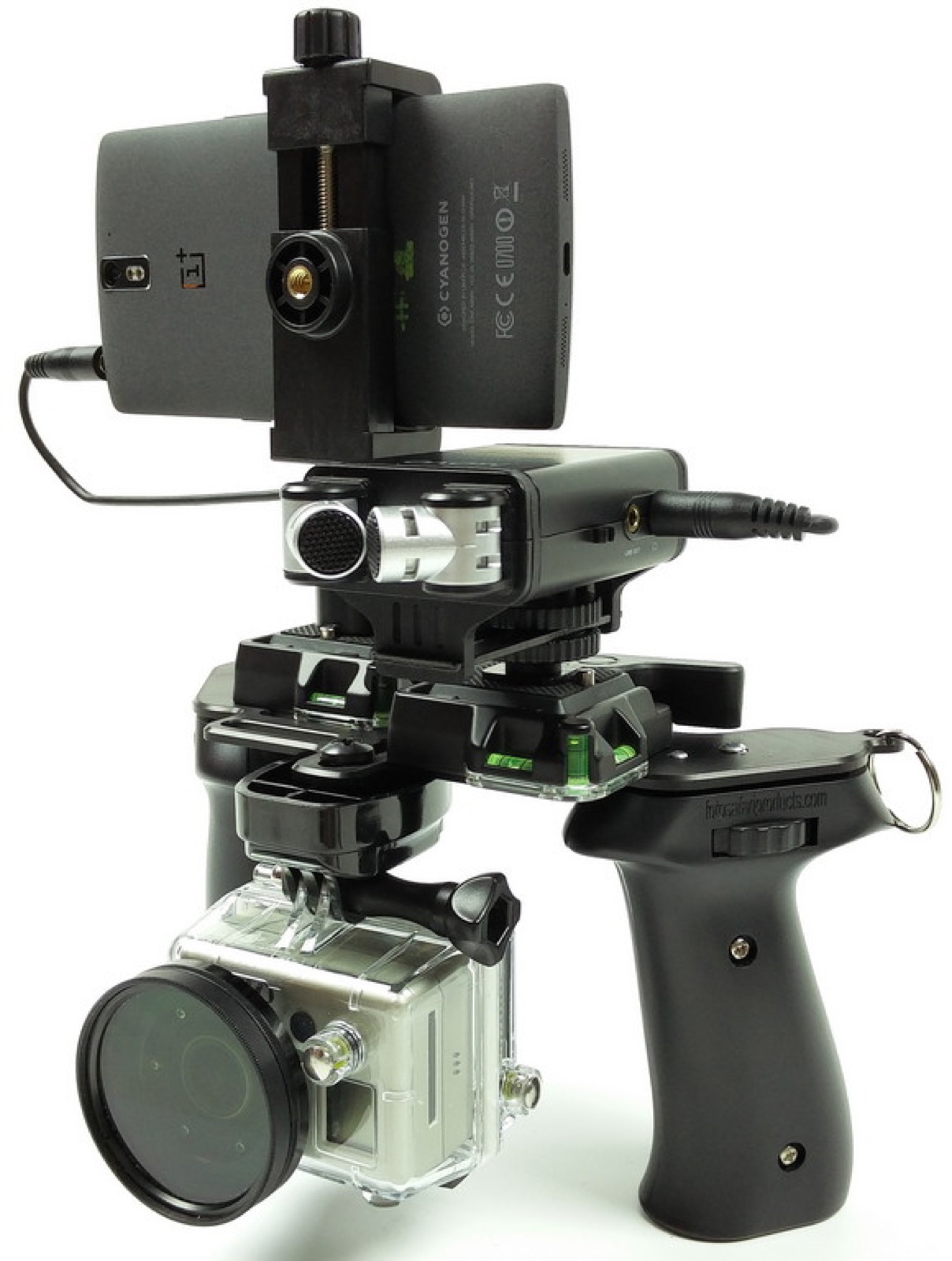 A dark phone clamped to a camera rig with a handle, and a small action camera mounted below it.